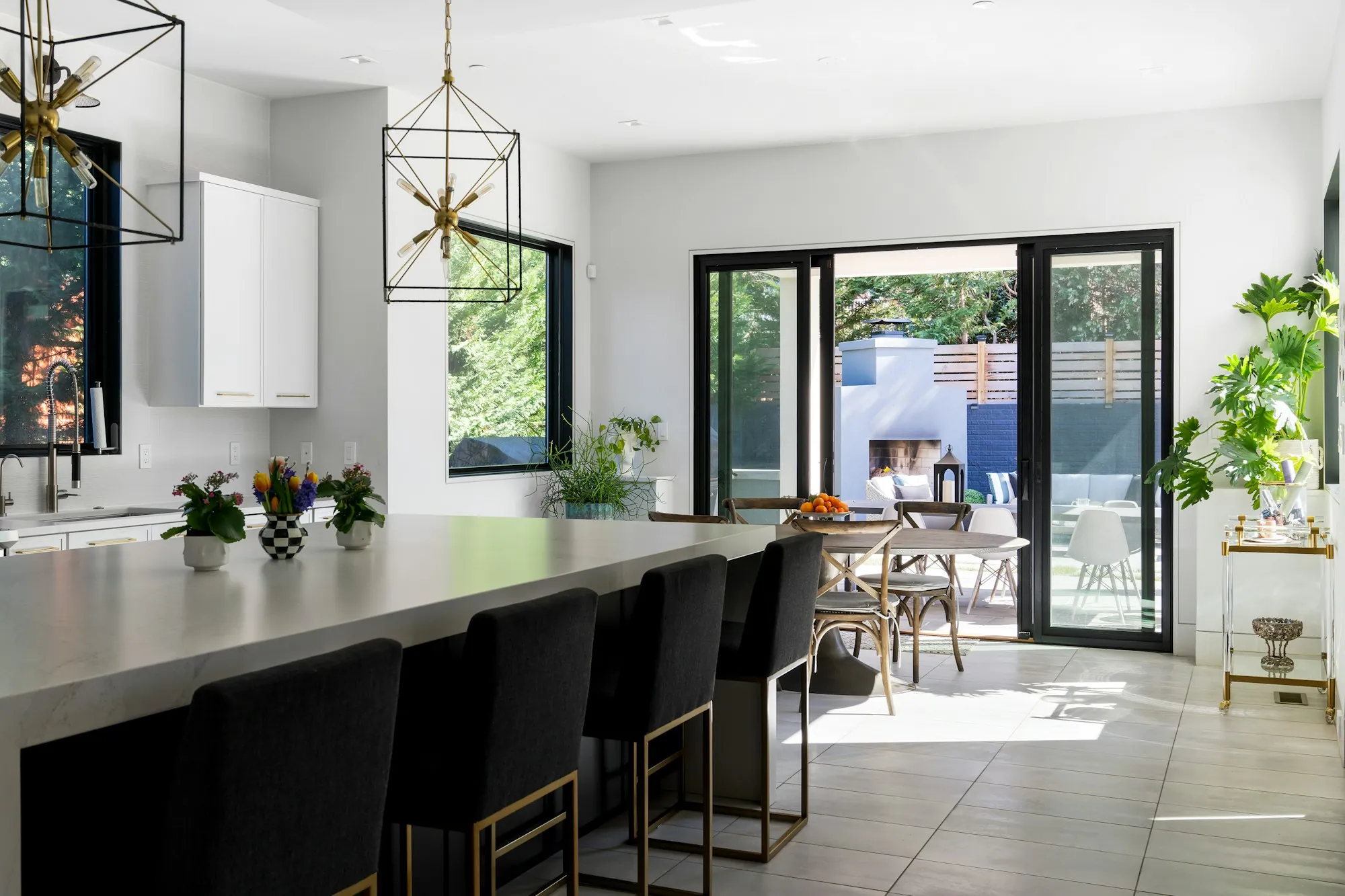 Remodeled kitchen with white shaker cabinets, a center island and pendant lights