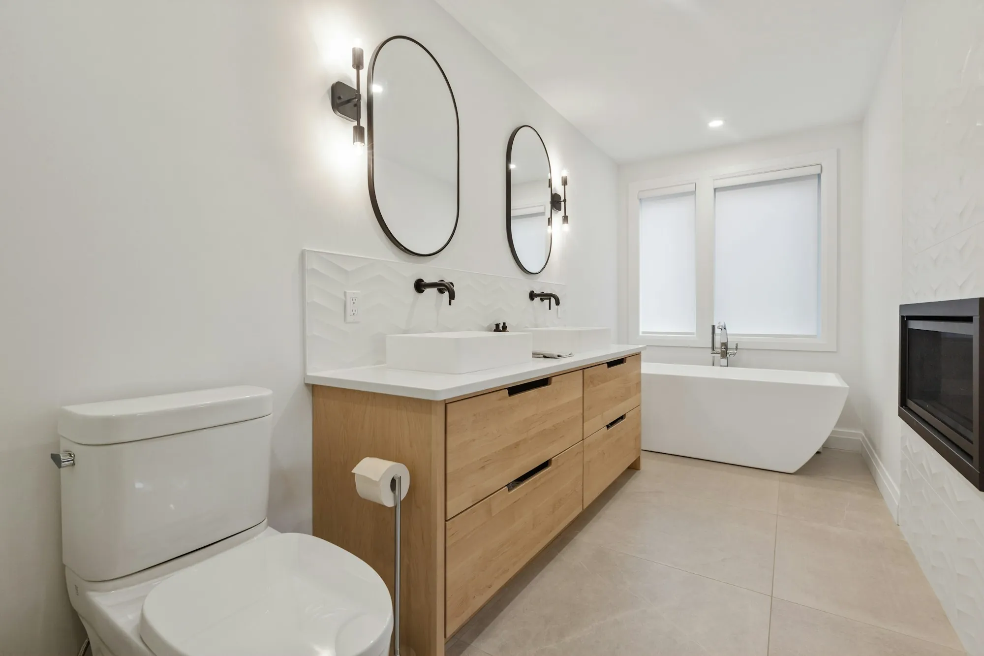 Tiled walk-in shower with a built-in niche and brushed fixtures